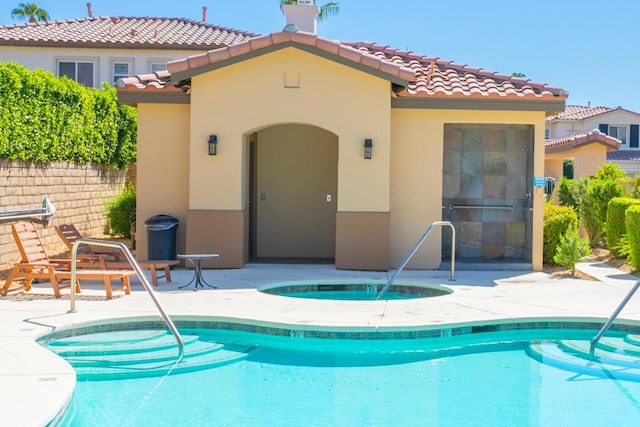 view of pool featuring an in ground hot tub and a patio area