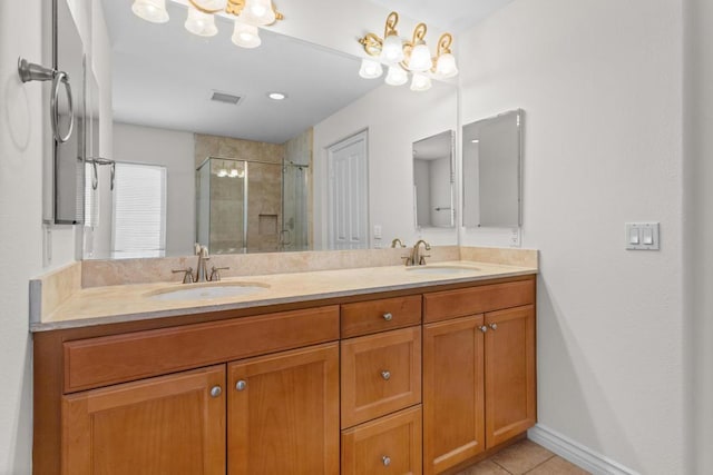 bathroom featuring tile patterned floors, an enclosed shower, and vanity