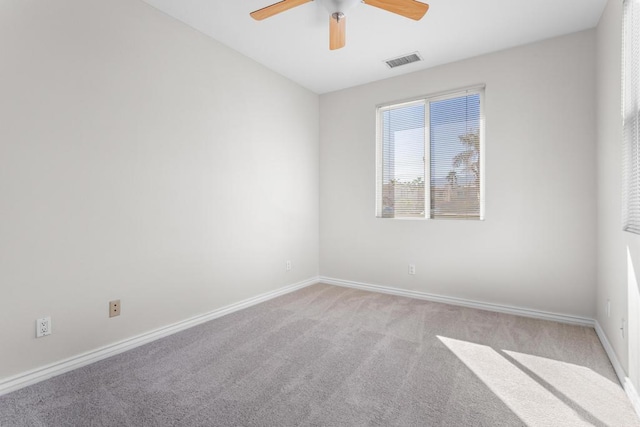 carpeted spare room with ceiling fan