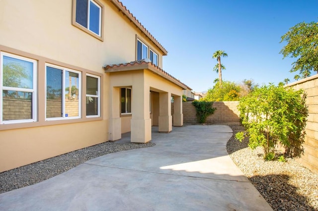 view of side of property featuring a patio