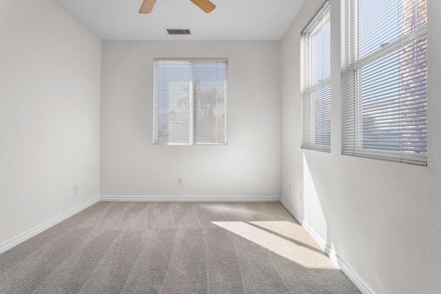 unfurnished room featuring ceiling fan and light colored carpet