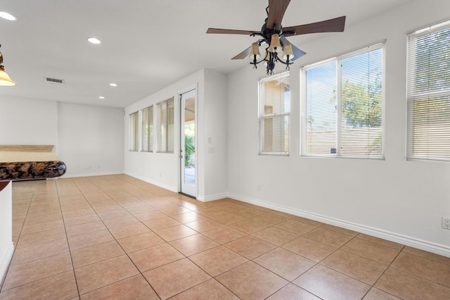 spare room featuring light tile patterned floors and ceiling fan