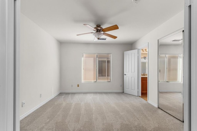 unfurnished bedroom featuring ceiling fan and light carpet