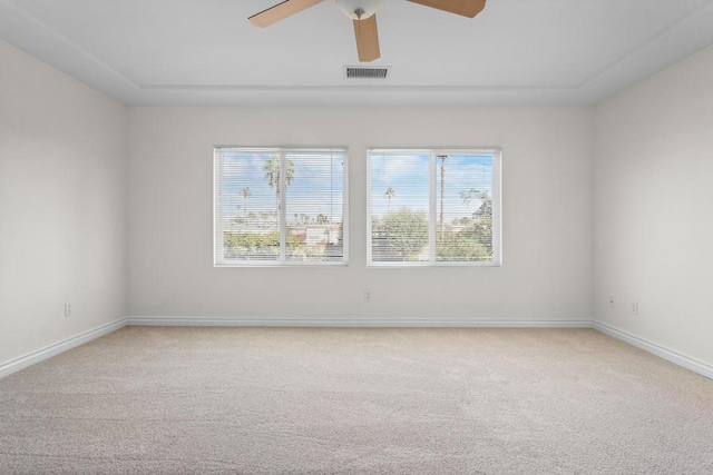 spare room featuring ceiling fan, carpet floors, and a healthy amount of sunlight