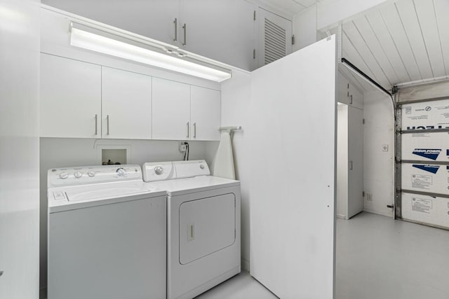 laundry room featuring independent washer and dryer and cabinets