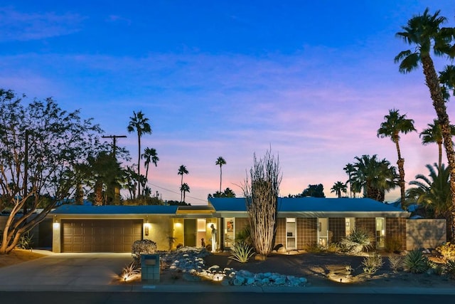 ranch-style home featuring a garage