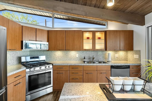 kitchen featuring wooden ceiling, stainless steel appliances, tasteful backsplash, vaulted ceiling with beams, and sink