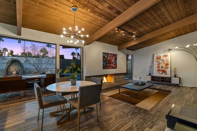 dining area with wood-type flooring, wood ceiling, an inviting chandelier, and rail lighting