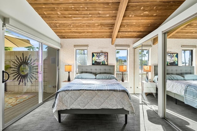 bedroom with carpet floors, vaulted ceiling with beams, and wood ceiling