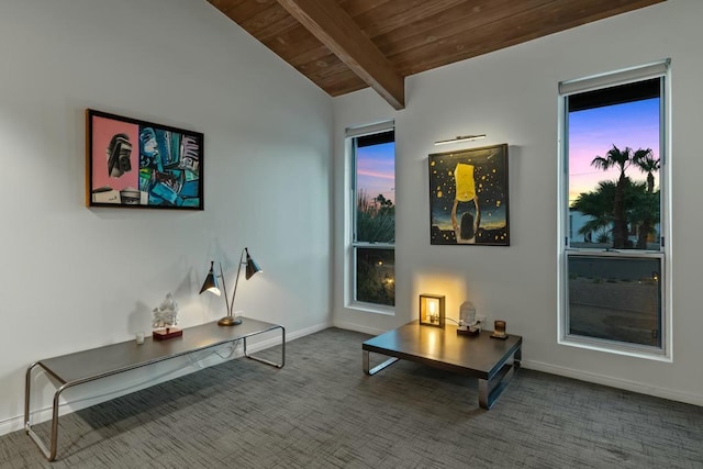 living area with carpet, lofted ceiling with beams, and wooden ceiling