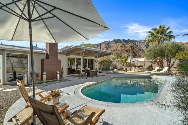 view of pool featuring a patio area and a mountain view