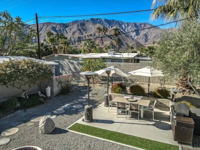 view of patio / terrace with a mountain view and area for grilling