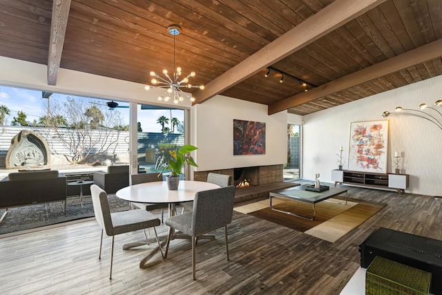 dining area with light hardwood / wood-style floors, plenty of natural light, and beam ceiling