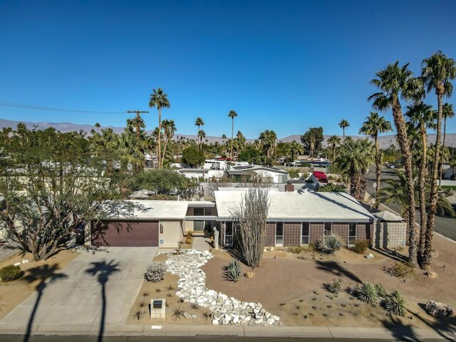 view of front of house with a garage and a mountain view