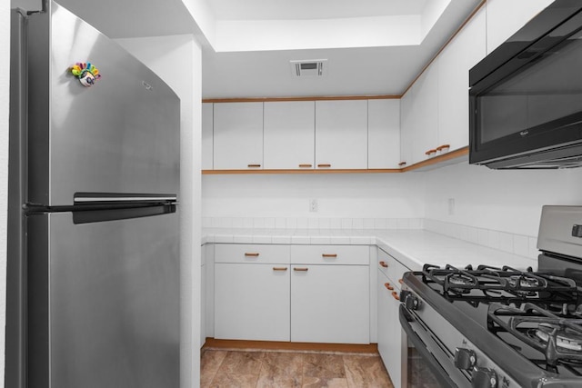 kitchen with white cabinetry and appliances with stainless steel finishes