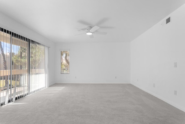 carpeted spare room with ceiling fan