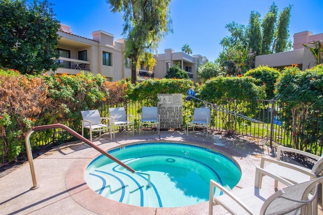 view of swimming pool with a community hot tub and a patio