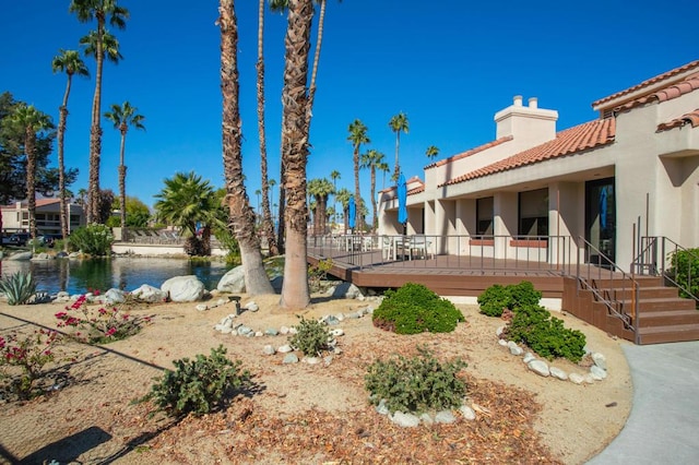 view of yard featuring a deck with water view