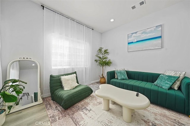 sitting room with wood-type flooring