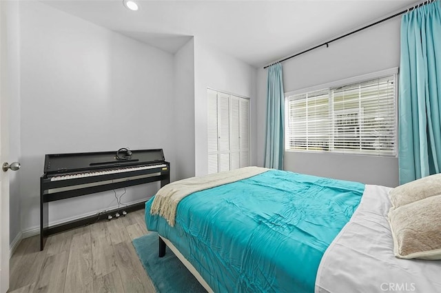 bedroom featuring a closet and light hardwood / wood-style flooring