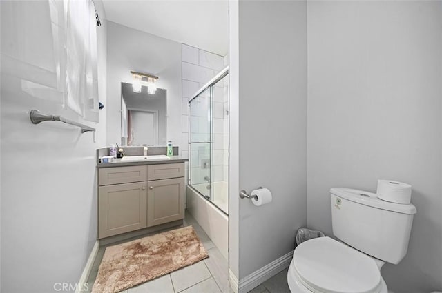 full bathroom featuring tile patterned floors, toilet, vanity, and shower / bath combination with glass door