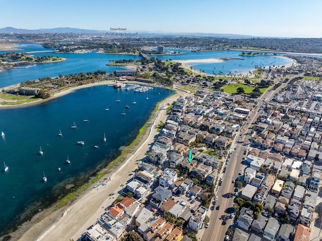 birds eye view of property with a water and mountain view