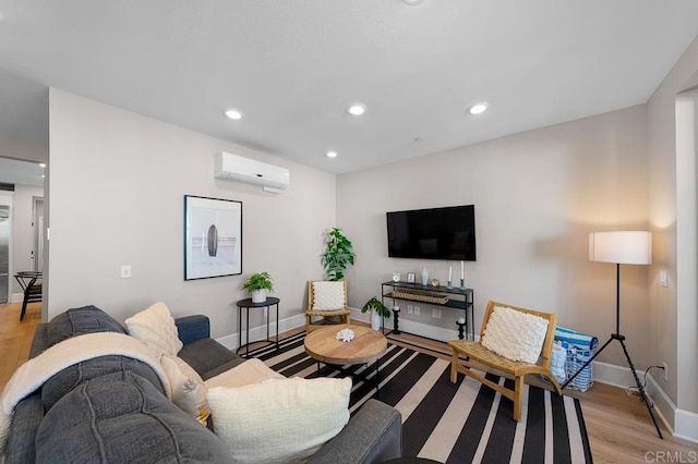 living room featuring a wall mounted AC and light wood-type flooring