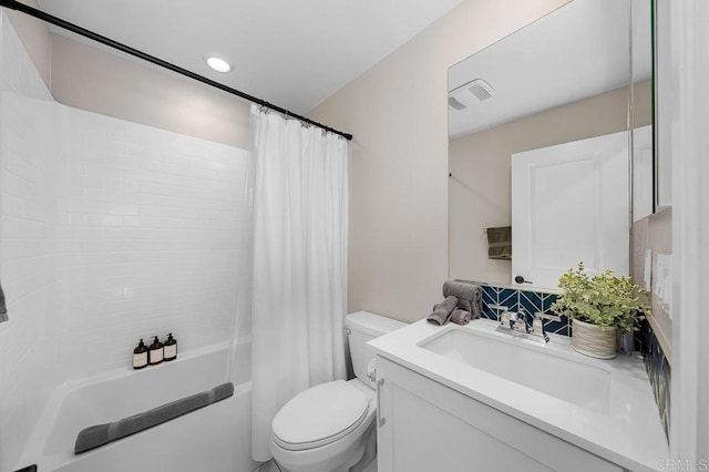 full bathroom featuring toilet, vanity, and shower / bath combo with shower curtain