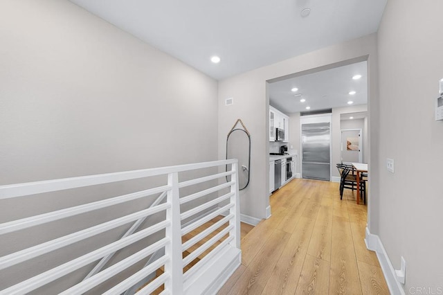 hallway with light wood-type flooring