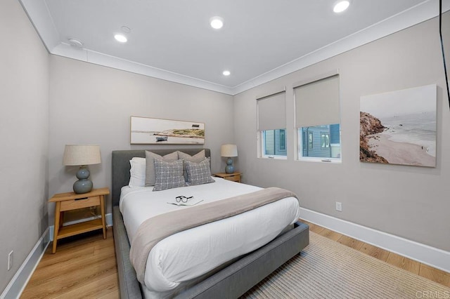 bedroom featuring crown molding and light wood-type flooring