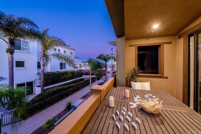 view of balcony at dusk