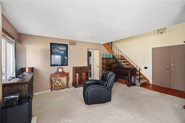 sitting room featuring carpet, visible vents, and stairway