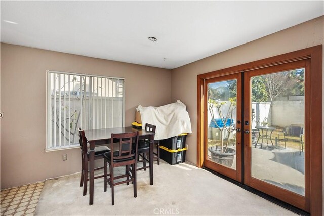 carpeted dining area with french doors