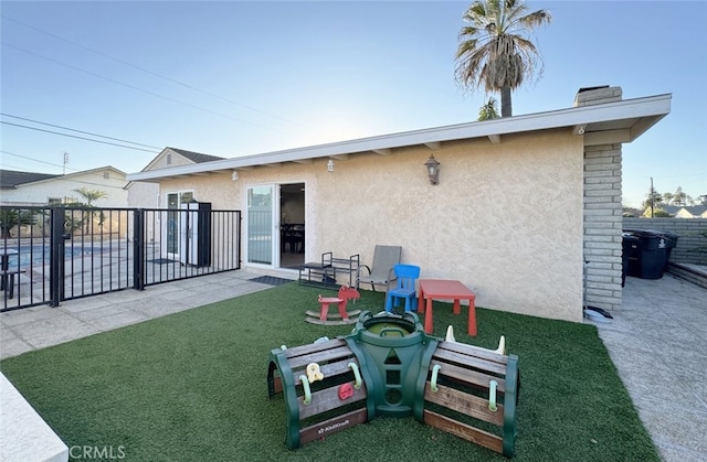 rear view of house featuring a lawn