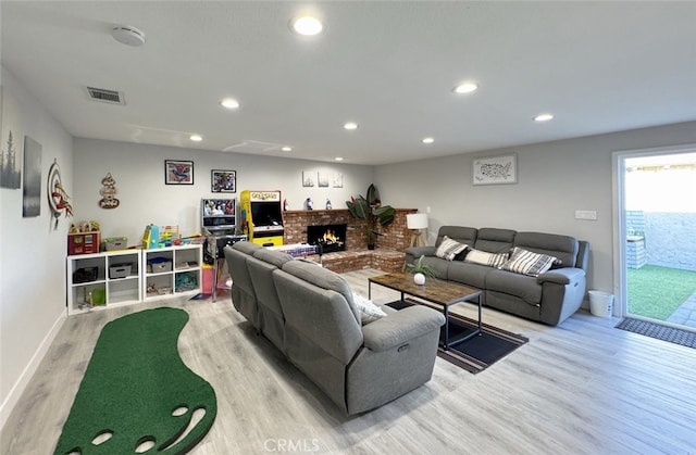 living room with light hardwood / wood-style flooring and a fireplace