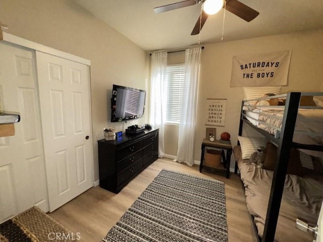 bedroom featuring a closet, light hardwood / wood-style flooring, and ceiling fan