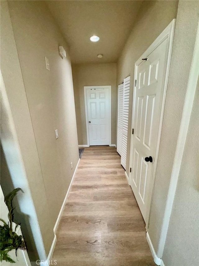 hallway with light wood-type flooring