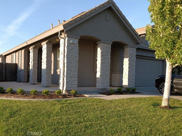 view of front of property with a front lawn and a garage