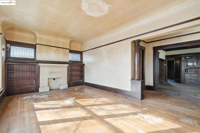 unfurnished living room featuring a fireplace and hardwood / wood-style flooring