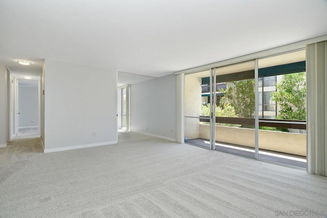 carpeted empty room with expansive windows