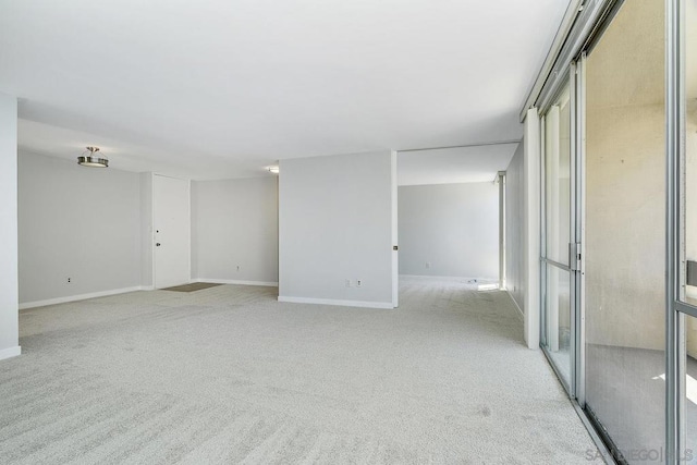 unfurnished room featuring light carpet