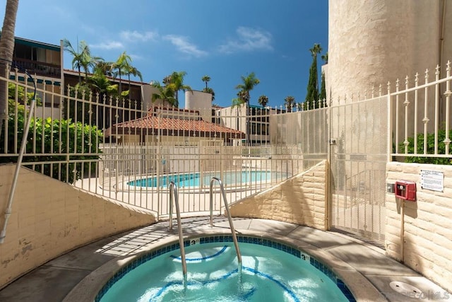 view of swimming pool with a community hot tub