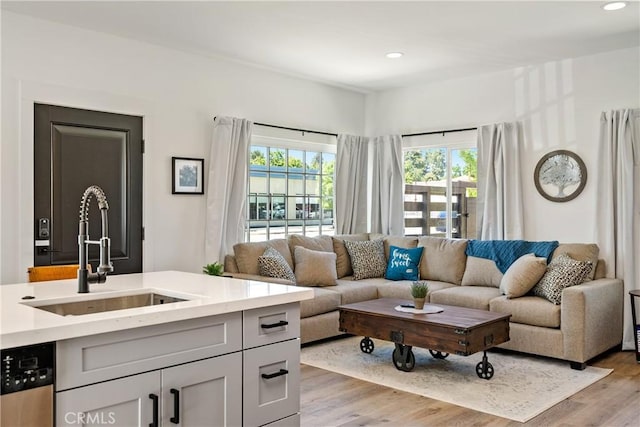 living room featuring light wood finished floors and recessed lighting