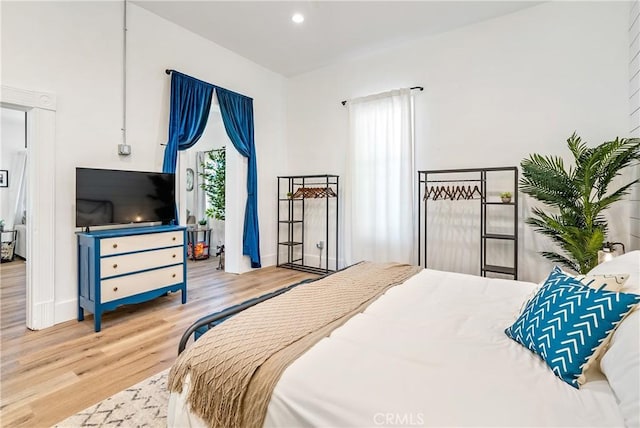 bedroom with recessed lighting and wood finished floors