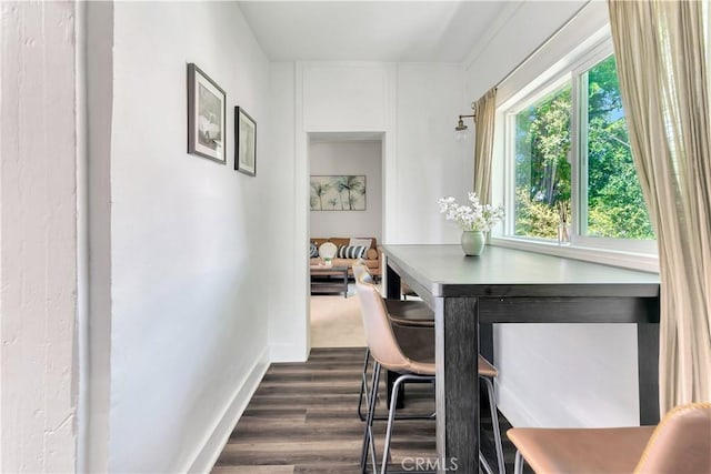 dining area featuring dark wood-style floors and baseboards