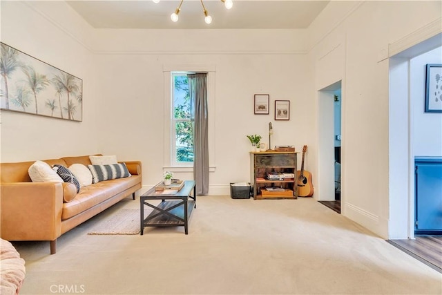 carpeted living room with baseboards