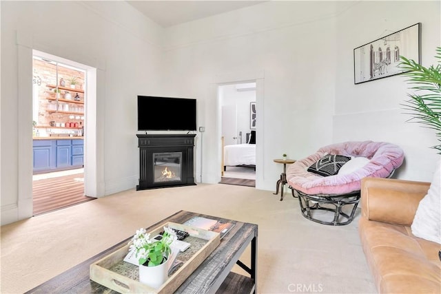 living room with a fireplace with flush hearth and carpet flooring