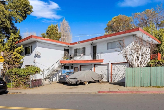 view of front of home featuring a garage and a balcony