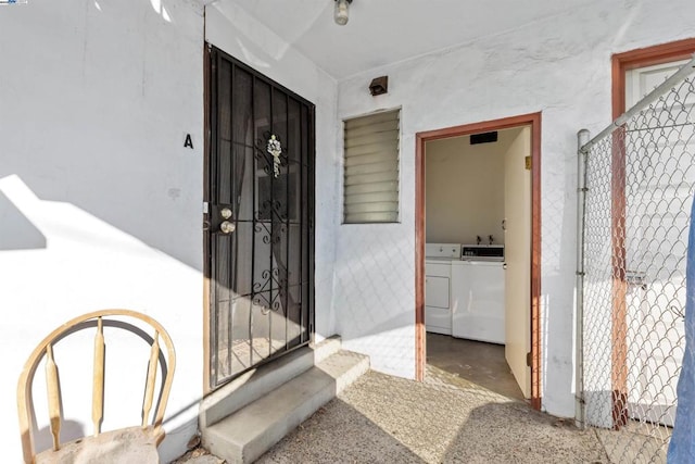 property entrance featuring independent washer and dryer