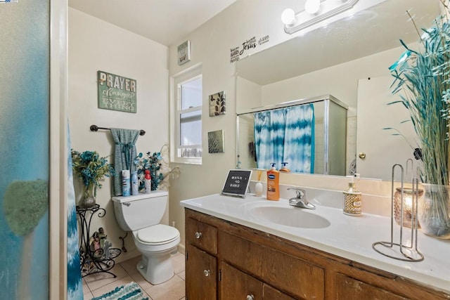 bathroom featuring toilet, vanity, tile patterned flooring, and curtained shower